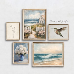 A French country coastal art grouping with five vintage-inspired printable pieces. The set includes a minimal botanical stem, a seaside cottage path leading toward the ocean, a hummingbird study, white hydrangeas in a blue vase, and rolling ocean waves on a sandy shore. The collection keeps the same soft neutral mood as the wider bundle while adding a breezy coastal note through pale sky blues, sea tones, creamy whites, and sun-washed beige.