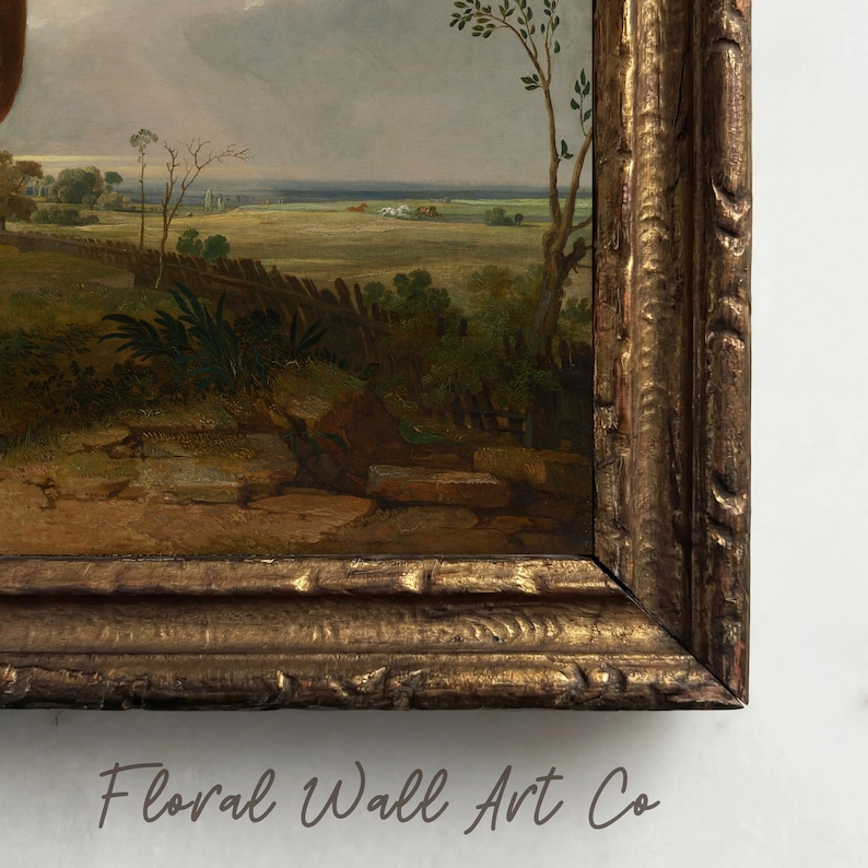 A close view of a vintage-style landscape print with an open field stretching into the distance beneath a soft gray sky. The painting includes a rustic fence line, low greenery, earthy foreground brushwork, and a quiet horizon with tiny buildings or haystacks in the distance. The artwork has an aged pastoral mood with brown, olive, muted gold, and gray tones, fitting the French country printable art bundle.