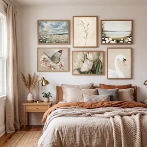 A coordinated French country bedroom art set with five vintage-style printable pieces. The artworks show a cloud-filled sky over a field of white blooms, a minimal stem botanical, a pale coastal landscape framed by white flowers, a butterfly hovering over soft blossoms, white tulips painted in loose brushstrokes, and a swan portrait on a warm neutral background. The palette is airy and calming with beige, cream, muted green, blue, and soft peach tones.