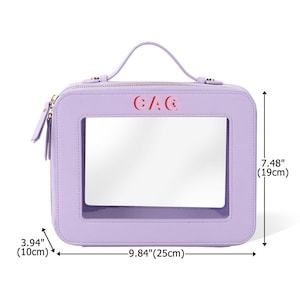 May include: A lavender cosmetic bag with a clear window and a top handle. The bag is rectangular, measuring 9.84 inches (25cm) wide, 3.94 inches (10cm) deep, and 7.48 inches (19cm) tall. The text "CAC" is printed in red on the front.
