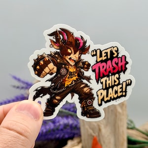 May include: A die-cut sticker featuring a cartoon goat character with pink-tipped horns, wearing a black leather jacket and yellow shirt, punching forward. The text reads "LET'S TRASH THIS PLACE!" in bold, stylized black and pink lettering.