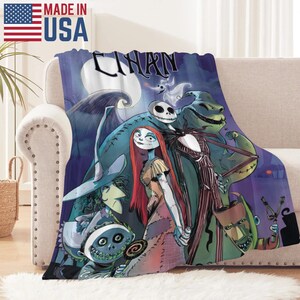May include: A plush throw blanket featuring characters from "The Nightmare Before Christmas" against a dark blue night sky with a full moon. The blanket displays Jack Skellington, Sally, and other characters. The words "CHARN" are visible on the blanket. Made in the USA.