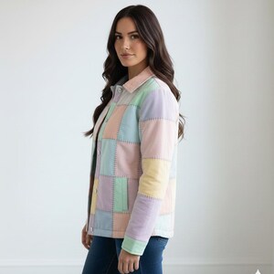 May include: A pastel patchwork jacket in shades of pink, blue, yellow, and lavender. The jacket has a button-up front and a collared neckline. The design features a quilted pattern with visible stitching.