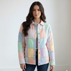 May include: A pastel patchwork jacket with a button-up front. The jacket features squares of pink, blue, green, and yellow fabric, stitched together with visible seams. The model is wearing the jacket with a gray shirt and blue jeans.