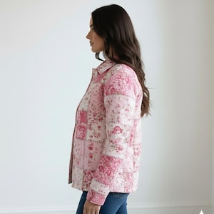 May include: A pink floral patchwork jacket with a button-down front. The jacket features a variety of floral patterns in shades of pink and white. The jacket is worn with blue jeans.