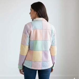 May include: A pastel patchwork jacket in shades of pink, blue, yellow, and green. The jacket features a collared neckline and button-up front. The design is made of squares stitched together with visible thread.