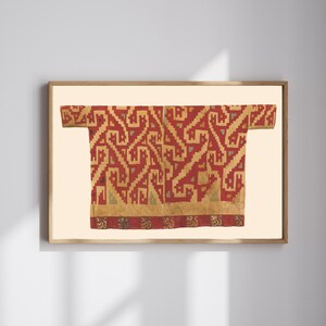 May include: A rectangular textile wall art piece featuring a red and tan geometric pattern with repeating stylized animal motifs. The design displays a central vertical seam and a horizontal border at the bottom, all encased in a light wood frame.