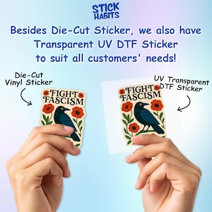 May include: Two stickers featuring a black crow perched among red poppy flowers and green leaves. The text FIGHT FASCISM is printed in black at the top of each sticker. One is a die-cut vinyl sticker and the other is a transparent UV DTF sticker.