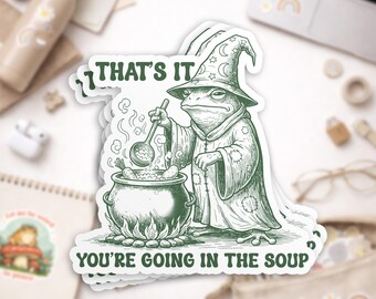 May include: Green and white sticker featuring a frog wizard stirring a cauldron. The sticker has the text "THAT'S IT" and "YOU'RE GOING IN THE SOUP". The sticker is waterproof and made of durable vinyl.