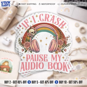 May include: A stack of white vinyl stickers with the text "IF I CRASH PAUSE MY AUDIO BOOK". The design features a rainbow, headphones, flowers, and a skull. The stickers are waterproof and durable.