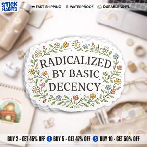 May include: A white sticker with the text "RADICALIZED BY BASIC DECENCY" in black, framed by a floral border. The sticker is on a white surface with stationery. The sticker is waterproof and made of durable vinyl.