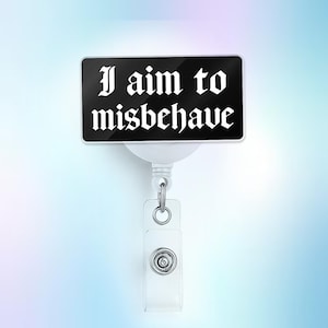 May include: A black rectangular badge reel with the phrase "I aim to misbehave" in white gothic font. The badge reel has a white retractable cord and a clear plastic holder with a metal snap.