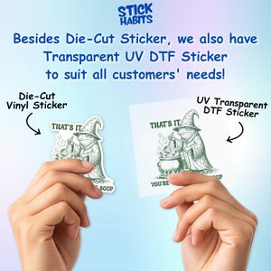 May include: Two stickers are shown, one die-cut vinyl and one UV transparent DTF. Both feature a cartoon frog in a wizard hat stirring a cauldron. The text "THAT'S IT" is above the frog, and "SOUP" and "YOU'RE" are below.