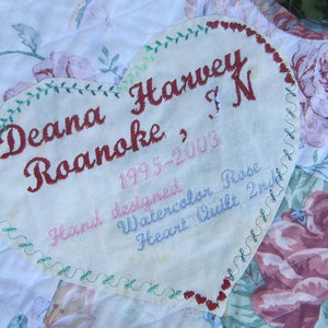 May include: A heart-shaped fabric label with embroidered text: "Deana Harvey Roanoke, 1995-2003, Hand designed, Watercolor Rose, Heart Quilt, Inc."