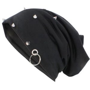 May include: Black beanie with silver studs and a silver ring attached. The beanie is made of a soft, stretchy fabric.