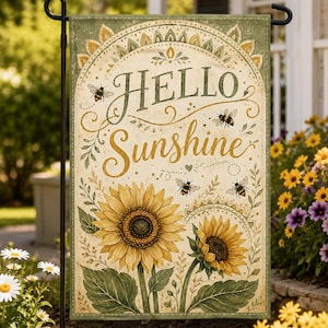 May include: A rectangular garden flag featuring the text "HELLO Sunshine" in dark green and gold script. The design includes two large yellow sunflowers with green leaves, four small bees, and decorative arched borders in shades of olive green.