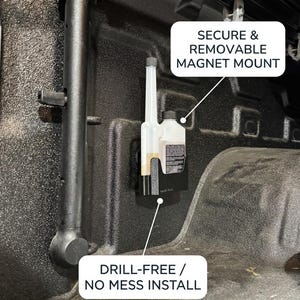 May include: A black magnet mount with a clear bottle and a black cap, installed inside a truck bed. The mount is labeled "Secure & Removable Magnet Mount" and "Drill-Free / No Mess Install".