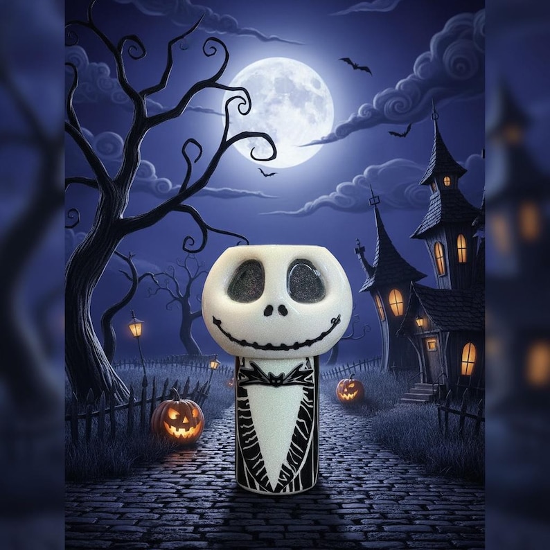May include: A white and black ceramic Jack Skellington-themed candle holder. The candle holder has a smiling face and is set against a spooky Halloween night scene with a full moon, pumpkins, and a haunted house.