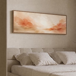 May include: A rectangular landscape wall art piece featuring abstract watercolour washes in shades of peach, terracotta, and soft beige. The artwork is enclosed in a thin, light-toned wooden frame, displaying a horizontal composition with soft edges.