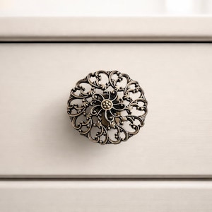 May include: A white ceramic mug with a black handle and the text "But First, Coffee" in a black, bold font. The mug is sitting on a wooden surface. The mug is 4 inches tall.