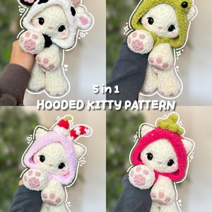 May include: Four white plush cat dolls with large black eyes and pink paw pads, each wearing a different crocheted hood: cow, frog, cherry, and strawberry. The text 5 in 1 HOODED KITTY PATTERN is centered over the four images of the toys.