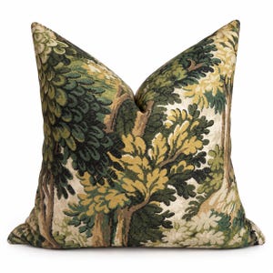 May include: A square throw pillow featuring a woven tapestry design of a dense forest landscape. The fabric displays intricate patterns of trees and foliage in shades of dark green, olive, light green, and cream, creating a detailed woodland scene.