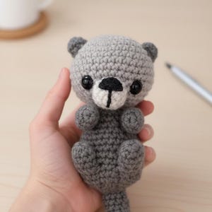 May include: A white ceramic mug with a black handle and the text "But First, Coffee" in a black, handwritten-style font. The mug is on a white surface.