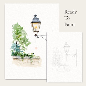 May include: A watercolour illustration of a street lamp with a small hanging heart, green foliage, and a brick wall, alongside a matching line drawing outline. The text Ready To Paint is printed in the upper right corner of the composition.