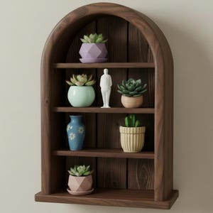 May include: A dark brown wooden arched shelf unit with multiple shelves. The shelves display various potted succulents, a small blue vase with floral designs, and a white figurine. The succulents are in various geometric and round pots.