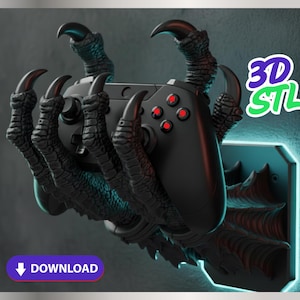 Może przedstawiać: Czarny kontroler do gier trzymany przez uchwyt w kształcie pazura. Uchwyt jest ciemnoszary z ostrymi pazurami i jest zamontowany na ścianie. Kontroler ma czerwone przyciski. Obraz zawiera tekst "3D STL" i "DOWNLOAD".