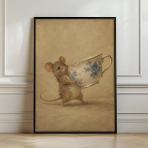 May include: A framed wall art print featuring a brown mouse standing on its hind legs and holding a large white teacup decorated with a blue floral pattern. The background is a solid, textured tan colour, and the frame is thin and black.