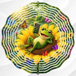 May include: A whimsical metal garden spinner featuring a green frog taking a selfie while lounging on a sunflower. Colorful butterflies flutter around the frog and flower, set against a backdrop of a sunny meadow.