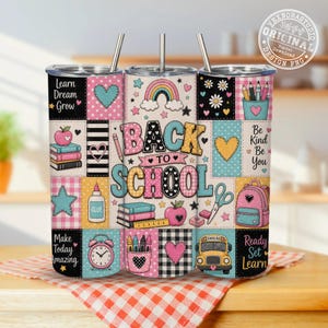Könnte beinhalten: Ein zylindrischer Becher mit Strohhalm und einem Patchwork-Design aus schulbezogenen Illustrationen wie Regenbogen, Büchern, Rucksack, Schulbus und Stiften. Der Text lautet Learn Dream Grow, Back To School, Be Kind Be You und Ready Set Learn.