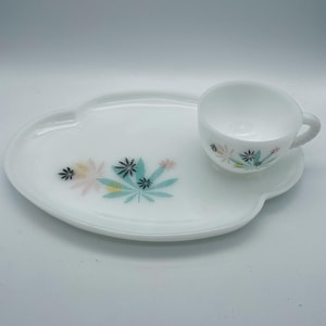 Peut inclure: Un service à thé vintage blanc avec une soucoupe et un plateau assorti. L'ensemble présente un motif floral aux couleurs pastel. Le plateau est en forme de nuage.