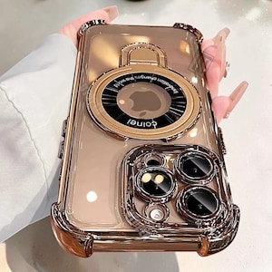 May include: Clear phone case with gold-colored accents. The case features a circular design with the text "colnei" and "Innovation changes the world". The case has a protective frame around the camera lenses.