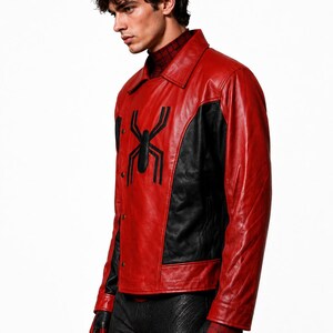 May include: Red and black leather jacket featuring a large black spider emblem on the chest. The jacket has a collared neckline and button closure. The sleeves and sides are black, and the gloves are red.