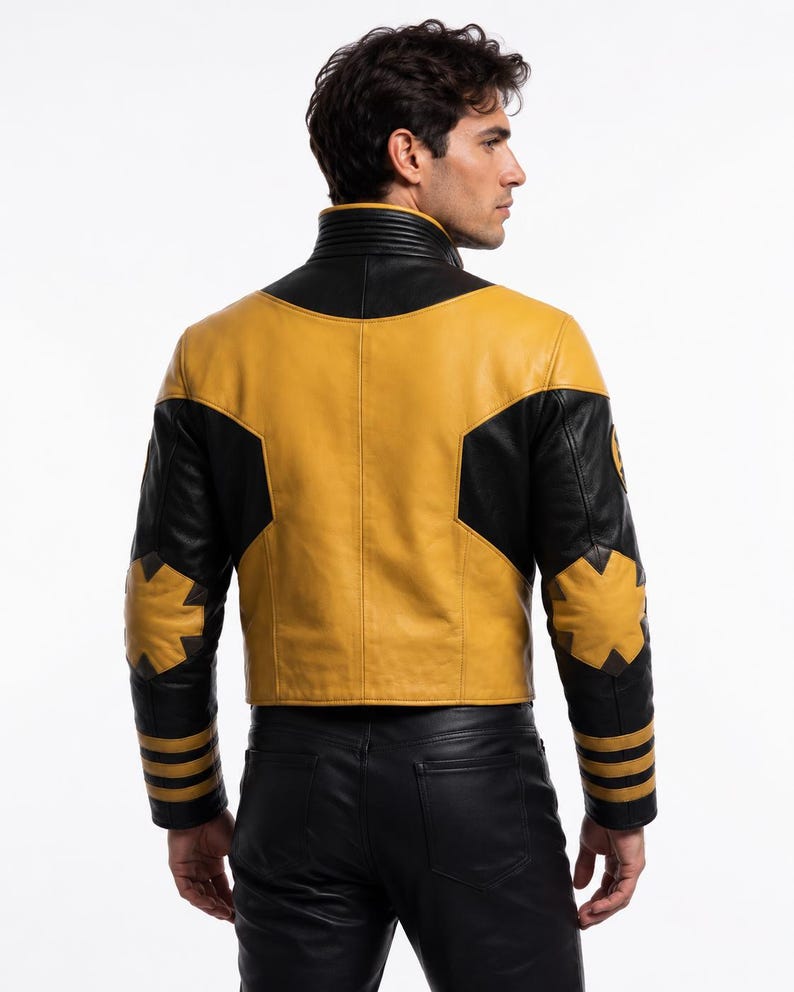 Op de afbeelding: Een leren jas met een mosterdgeel en zwart kleurblokontwerp. De jas heeft een hoge kraag met geribbelde details, stervormige patches op de ellebogen en drie horizontale strepen op elke mouwboord. Gedragen met een zwarte broek.