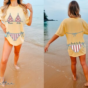 Bride tribe vacation shirt featuring playful bikini graphics and personalized bridal party text options.