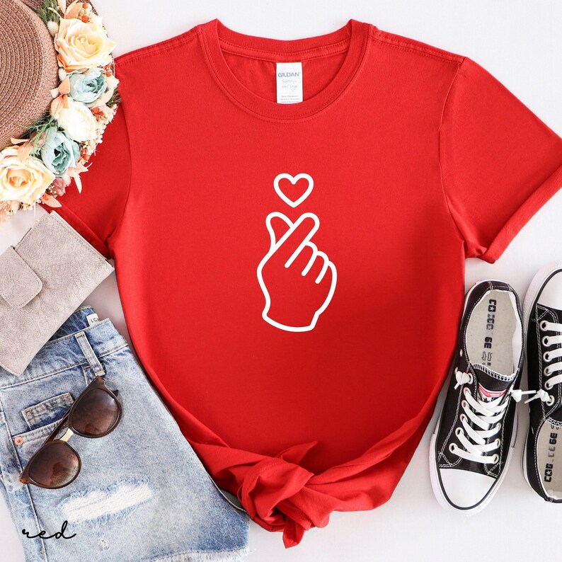 Aesthetic finger heart design shirt with modern line art, ideal for casual wear and subtle love expression