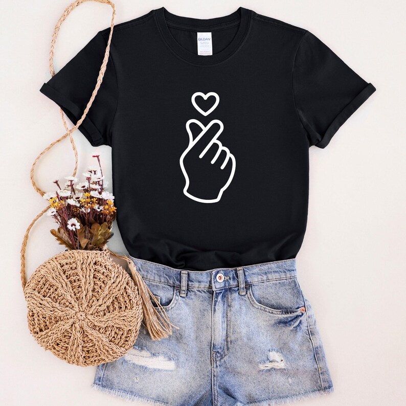 Minimalist t-shirt with Korean finger heart symbol, simple love graphic design for everyday casual wear