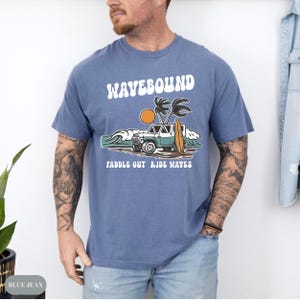 Coastal adventure t-shirt design with surfboard, rugged beach vehicle, ocean waves and windblown palm trees in a retro surf club illustration.