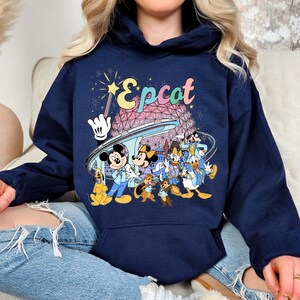 May include: A set of three ceramic mugs with a speckled, matte finish. The mugs are in shades of cream, light gray, and dark gray. Each mug has a simple, minimalist design and a rounded handle. Perfect for coffee or tea.