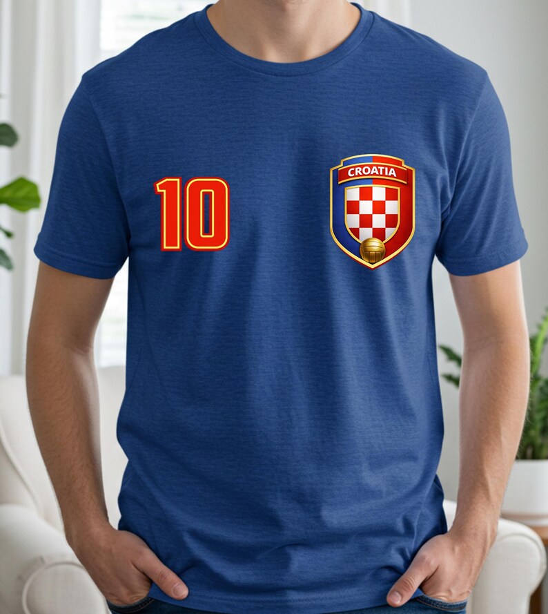 May include: A blue t-shirt featuring the number 10 in red with a gold outline on the left side. On the right side is a Croatian crest with a red and white checkered pattern, the word "Croatia", and a soccer ball.