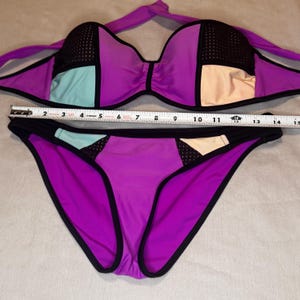 May include: A set of three ceramic mugs with a speckled, matte finish in cream, light grey, and dark grey. Each mug has a simple, modern design and a rounded handle.