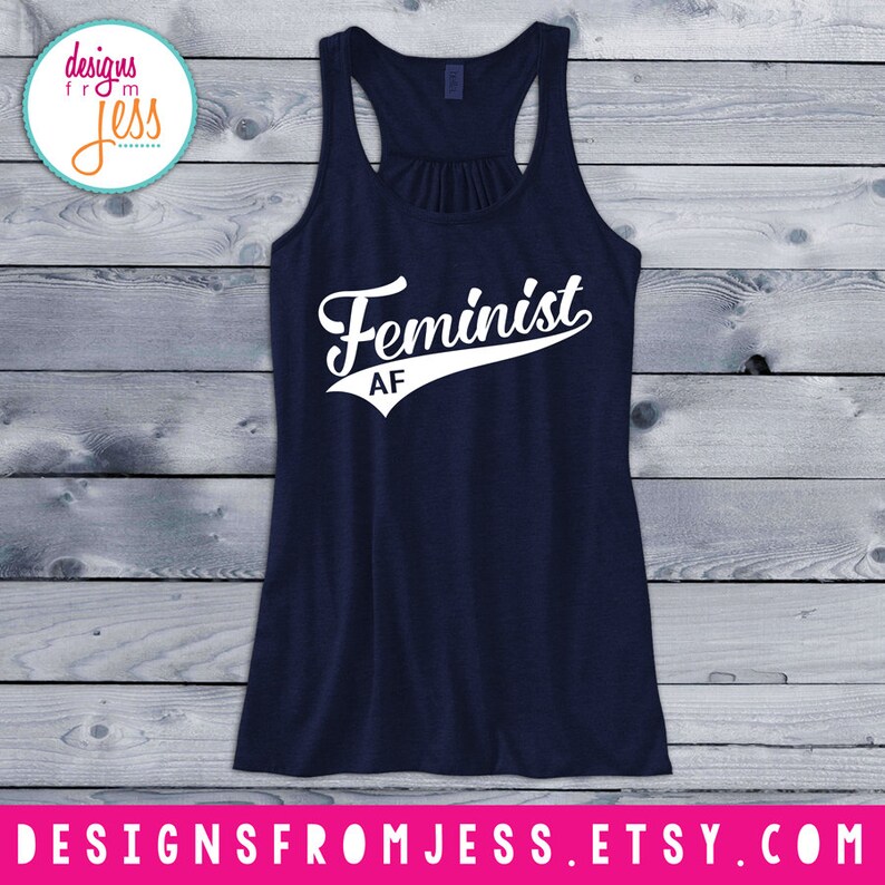 May include: A navy blue tank top with a white graphic that says "Feminist AF" in a baseball-style font.