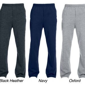 May include: Three pairs of sweatpants in different colours: black heather, navy, and oxford grey. The sweatpants have a drawstring waistband and side pockets.