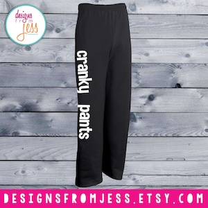 May include: Black sweatpants with the text "cranky pants" printed vertically on the left leg in white.