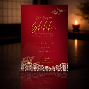 May include: A red invitation card with gold text and design elements. The card reads "It's a Surprise, Shhh..." and includes event details. A turtle and wave design is at the bottom. A candle is in the background.