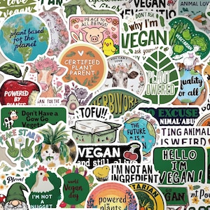 May include: A selection of vibrant vegan-themed stickers featuring diverse designs and text. Stickers display phrases such as "Vegan," "Plant Powered," and "Love Animals Eat Plants." Images include animals, plants, and cartoon characters.