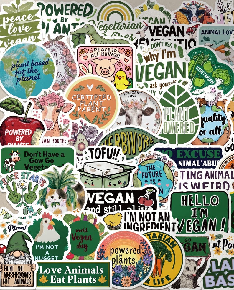 May include: A collection of colorful vegan-themed stickers with various designs and text. Stickers include phrases like "Vegan," "Plant Powered," and "Love Animals Eat Plants." Images include animals, plants, and cartoon characters.